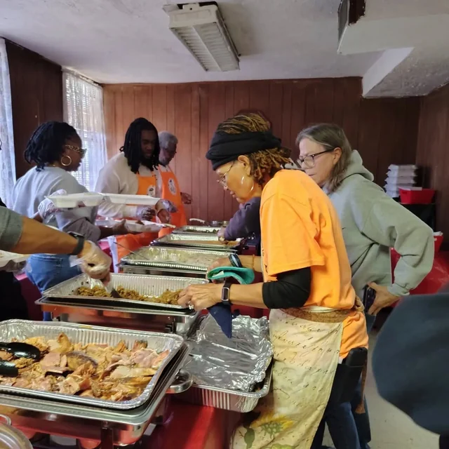 People sharing the work of serving a meal at True Light